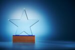 crystal star shape trophy against blue background