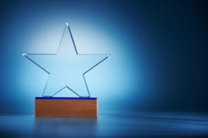 crystal star shape trophy against blue background